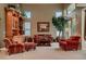 Bright living room with a large built-in wooden cabinet and comfortable seating at 3042 Hammerwood Dr, Las Vegas, NV 89135