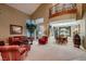 Bright and airy living room with vaulted ceilings and elegant decor, leading into the dining area at 3042 Hammerwood Dr, Las Vegas, NV 89135