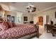 Main bedroom with king-size bed, en-suite bathroom, and sitting area at 3042 Hammerwood Dr, Las Vegas, NV 89135