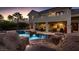 Luxury pool with waterfall feature and outdoor patio at 3042 Hammerwood Dr, Las Vegas, NV 89135