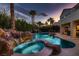Beautiful backyard pool with waterfall feature and lush landscaping, perfect for outdoor relaxation at 3042 Hammerwood Dr, Las Vegas, NV 89135