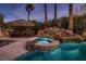 Inviting pool and spa with waterfall feature and tiki bar at 3042 Hammerwood Dr, Las Vegas, NV 89135