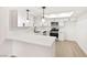 Modern white kitchen with stainless steel appliances and quartz countertops at 3768 Territory St, Las Vegas, NV 89121