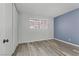 Spacious bedroom with blue accent wall and wood-look floors at 3801 Daisy St # 42, Las Vegas, NV 89119