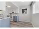 Kitchen area featuring white appliances, painted cabinets and modern fixtures at 3801 Daisy St # 42, Las Vegas, NV 89119