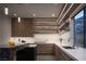 Modern kitchen with sleek cabinetry,floating shelves, and granite island at 410 Tranquil Peak Ct, Henderson, NV 89012