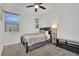 Cozy bedroom with a ceiling fan, gray carpeting, and a double closet at 525 Front Range Ln, North Las Vegas, NV 89084