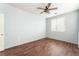 Bedroom with wood floors, ceiling fan and window with blinds at 5738 Wind Tower St, North Las Vegas, NV 89031