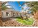 Inviting backyard oasis with a fire pit, pool, and palm trees at 5900 Negril Ave, Las Vegas, NV 89130