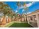 Landscaped backyard with artificial turf and palm trees at 5900 Negril Ave, Las Vegas, NV 89130