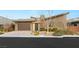 Modern home exterior with attached garage and landscaping at 6056 Willow Rock St, Las Vegas, NV 89135