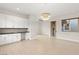 Bright laundry room with white cabinets and a side wet bar at 6056 Willow Rock St, Las Vegas, NV 89135