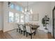 Elegant dining room with a large chandelier and hardwood floors at 6706 Pyracantha Glen Ct, Las Vegas, NV 89131