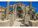 Elegant home exterior with stone accents and wrought iron gate at 6706 Pyracantha Glen Ct, Las Vegas, NV 89131