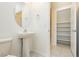 Simple bathroom with pedestal sink and built-in shelving at 675 Omaggio Pl, Henderson, NV 89011