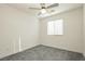 Well-lit bedroom featuring gray carpet and ceiling fan at 675 Omaggio Pl, Henderson, NV 89011