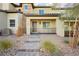 Two-story townhome with attractive stone accents and a welcoming front porch at 675 Omaggio Pl, Henderson, NV 89011