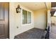 Covered patio with brick flooring, a door and window with blinds at 675 Omaggio Pl, Henderson, NV 89011