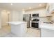 Modern kitchen with island, stainless steel appliances, and white cabinets at 675 Omaggio Pl, Henderson, NV 89011