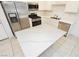 Modern kitchen with a large quartz island and stainless steel appliances at 675 Omaggio Pl, Henderson, NV 89011