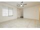 Bright and airy living room with tile floors and ceiling fan at 675 Omaggio Pl, Henderson, NV 89011