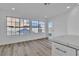 Bright dining area with wood-look floors and large windows at 7640 Sea Wind Dr, Las Vegas, NV 89128