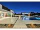 Luxury pool with fountains, fire pit, and outdoor kitchen at 7815 W La Madre Way, Las Vegas, NV 89149