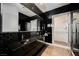 Black and white bathroom with double vanity and a glass shower at 7815 W La Madre Way, Las Vegas, NV 89149