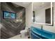 Stylish powder room with blue sink and marble walls at 7815 W La Madre Way, Las Vegas, NV 89149