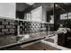 Modern bathroom with black tile, double vanity, and a glass enclosure at 7815 W La Madre Way, Las Vegas, NV 89149