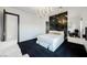 Modern bedroom with a large bed, dark carpet, and a unique wall feature at 7815 W La Madre Way, Las Vegas, NV 89149