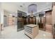 Spacious walk-in closet with mirrored doors and island at 7815 W La Madre Way, Las Vegas, NV 89149