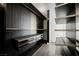 Spacious walk-in closet with dark wood shelving and drawers at 7815 W La Madre Way, Las Vegas, NV 89149