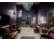 Luxurious game room with leather seating, a fireplace, and a slot machine at 7815 W La Madre Way, Las Vegas, NV 89149