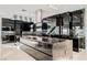 Modern kitchen with dark cabinets, marble countertops, and a large island at 7815 W La Madre Way, Las Vegas, NV 89149