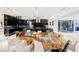 Modern kitchen with large island, high-end appliances, and live-edge dining table at 7815 W La Madre Way, Las Vegas, NV 89149