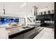 Sleek kitchen with dark cabinetry, marble countertops, and a large island at 7815 W La Madre Way, Las Vegas, NV 89149