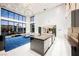 Modern kitchen with island and living room view at 7815 W La Madre Way, Las Vegas, NV 89149