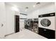Laundry room with high-end washer, dryer, and storage at 7815 W La Madre Way, Las Vegas, NV 89149