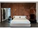 Main bedroom with king bed and a stunning geometric dark wood accent wall at 7815 W La Madre Way, Las Vegas, NV 89149