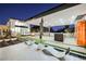 Modern outdoor kitchen and lounge area under a covered patio at 7815 W La Madre Way, Las Vegas, NV 89149
