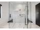 Large walk-in glass shower with marble tile and built in shelving at 7815 W La Madre Way, Las Vegas, NV 89149