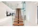 Modern glass and wood staircase with open risers, view of living area at 7815 W La Madre Way, Las Vegas, NV 89149