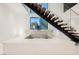 Built-in water feature with a modern design, located beneath a staircase at 7815 W La Madre Way, Las Vegas, NV 89149