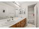 Bathroom featuring dual sinks, a shower, and a bathtub at 9236 Arbor Glen St, Las Vegas, NV 89123