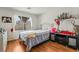 Bedroom with hardwood floors, a window, and black furniture at 9236 Arbor Glen St, Las Vegas, NV 89123