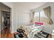 Bright bedroom featuring wood floors, a massage table, and white closet doors at 9236 Arbor Glen St, Las Vegas, NV 89123