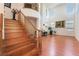Grand foyer with hardwood floors, staircase, and large windows providing natural light at 9236 Arbor Glen St, Las Vegas, NV 89123