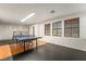 Spacious game room featuring a ping pong table, hardwood floors, and natural light at 9236 Arbor Glen St, Las Vegas, NV 89123