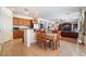 Kitchen and Dining Area featuring wood cabinets, granite counters and open access to the Living Room at 9236 Arbor Glen St, Las Vegas, NV 89123